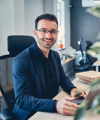 portrait-of-a-smiling-businessman-in-his-office-2021-09-03-15-39-47-utc-e1641646157253.jpg